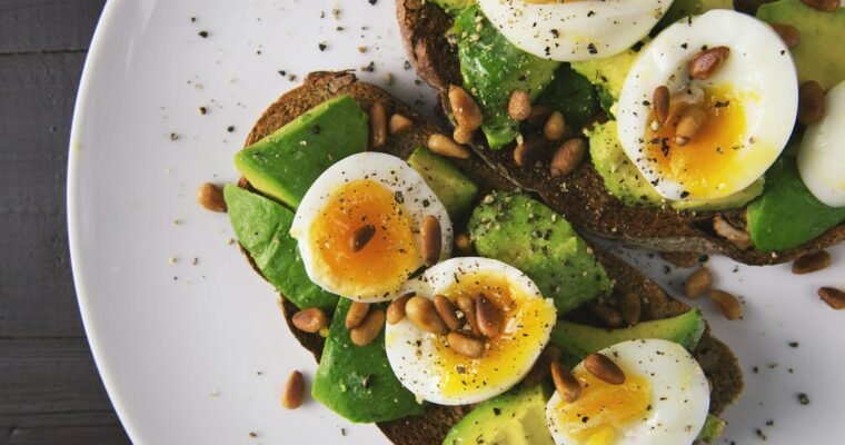 Healthy breakfast with boiled eggs and avocado